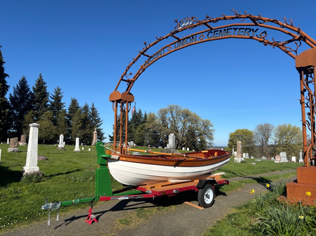 The classic Catspaw Dinghy “Beau,” a handcrafted wooden rowboat in pristine condition, ready to find a new steward while supporting Mount Union Cemetery
